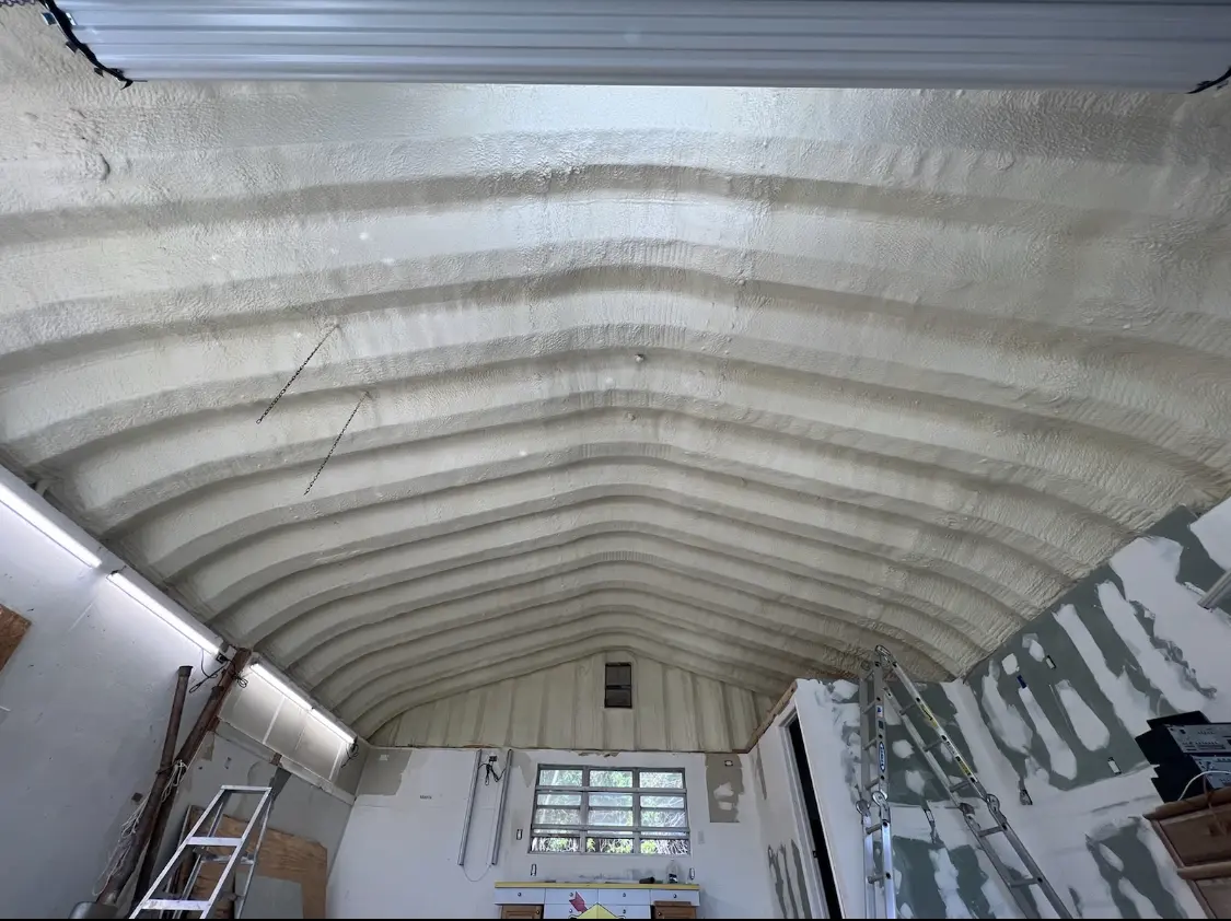 Spray polyurethane foam applied to the underside of a metal roof deck in Owasso